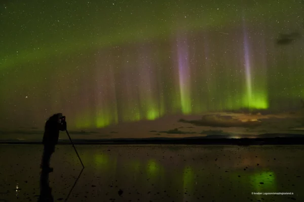 Photographer taking pictures of the northern lights in Iceland