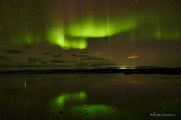 Northern lights reflecting on the bay of Hvammsfjörður in west Iceland