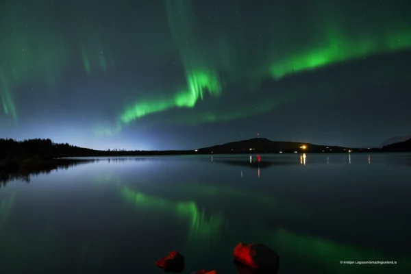 Reflection of Northern lights over lake Hafravatn in Iceland