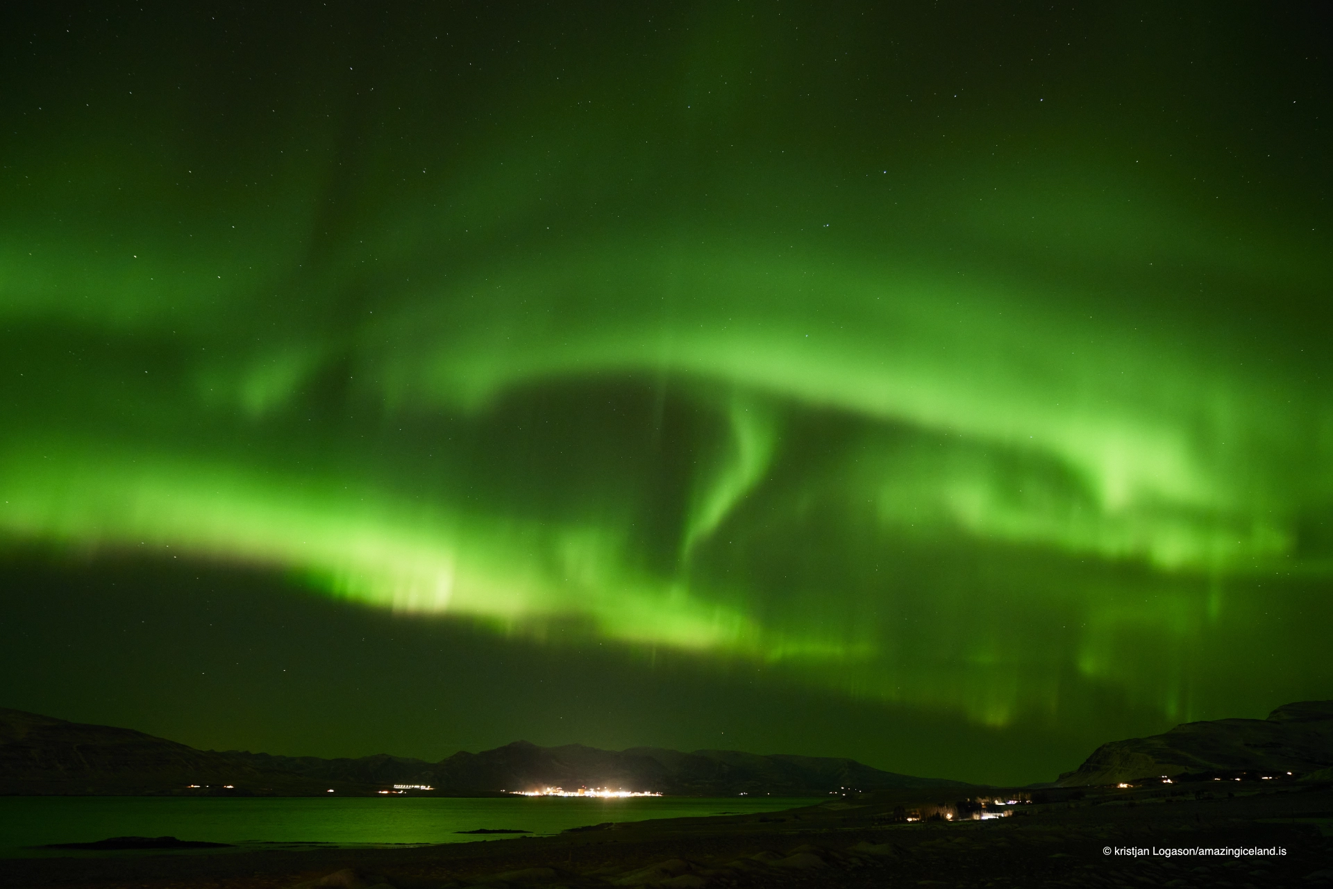 Aurora Borealis or Northern lights over Hvalfjörður bay in Iceland