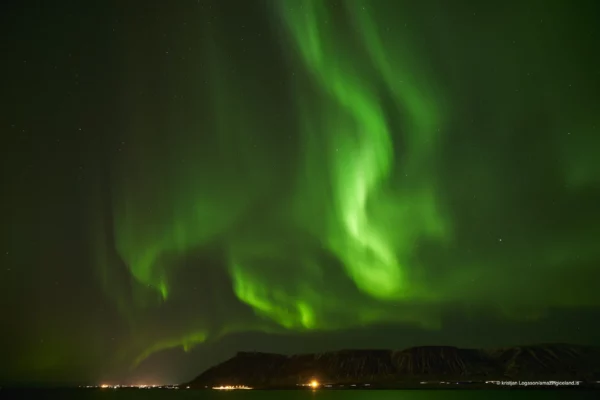 Aurora Borealis or Northern lights over Hvalfjörður bay in Iceland